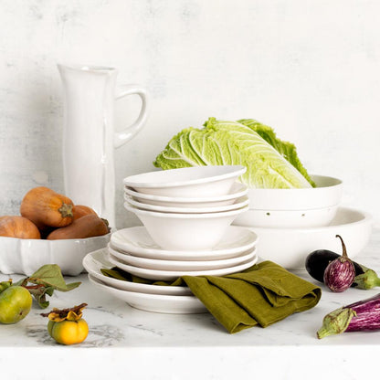 Aloe green hand-dyed linen napkin, 22" square, folded beside white ceramic dishes and fresh produce.