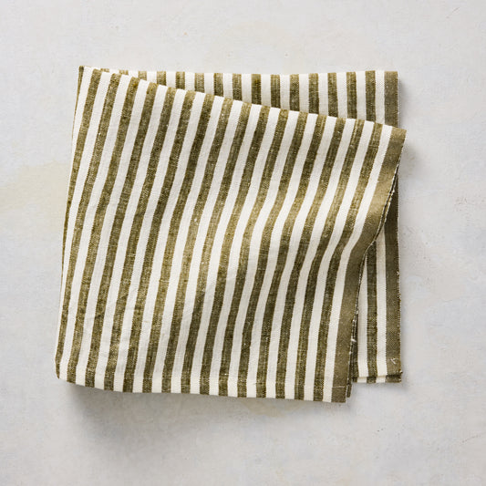 Folded 21-inch square linen napkin with green and white ticking stripes on a neutral background.