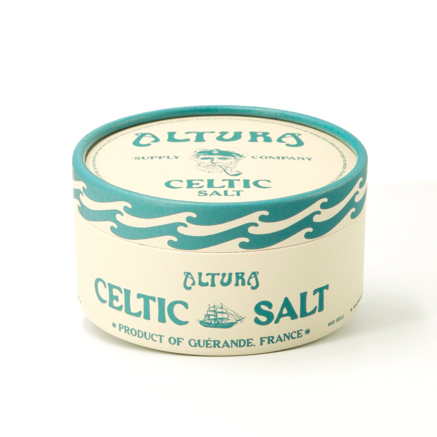 Altura Celtic Salt in a round, cream and teal container with a sailor and ship design.