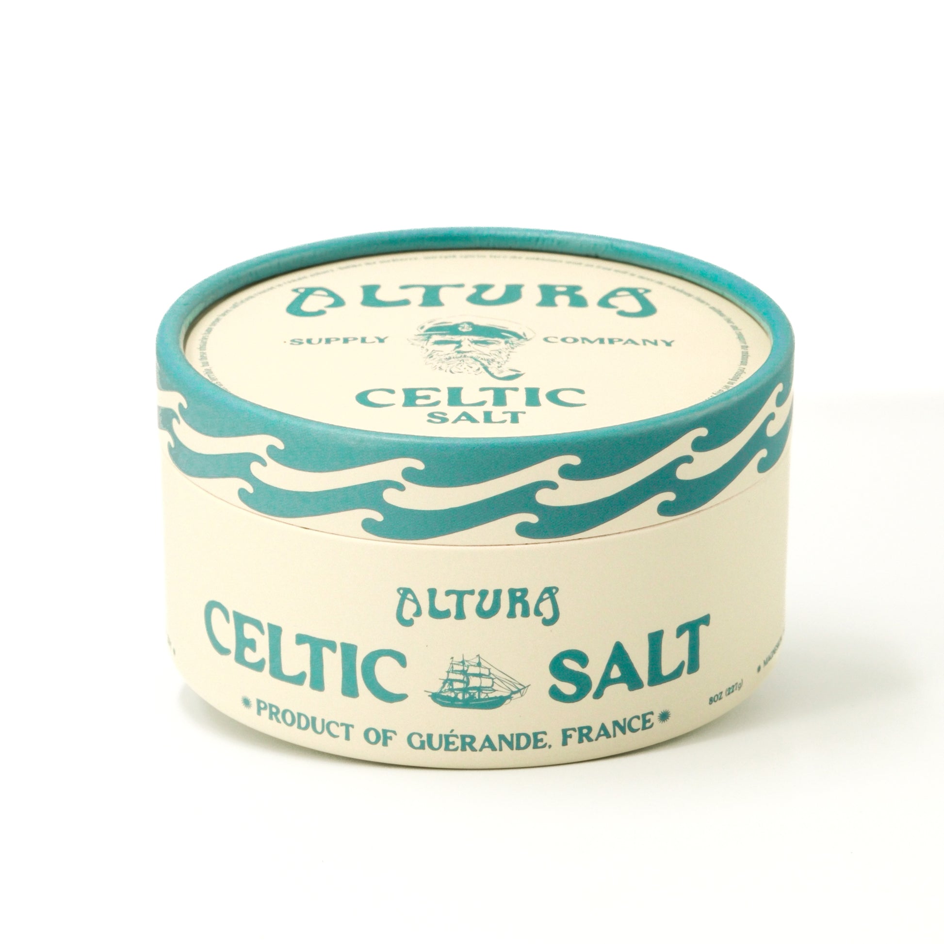 Altura Celtic Salt in a round, cream and teal container with a sailor and ship design.