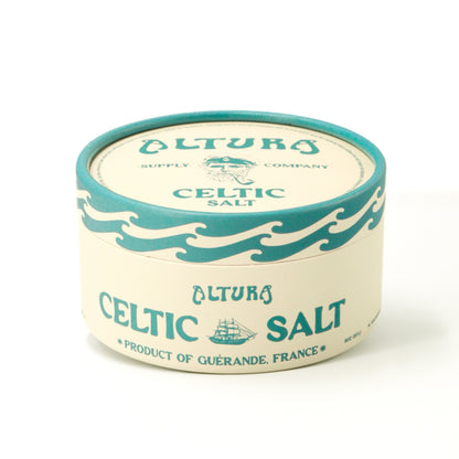 Altura Celtic Salt in a round, cream and teal container with a sailor and ship design.