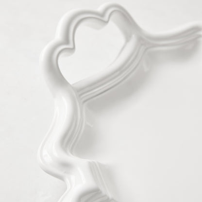 White ceramic Amalfi serving platter with scalloped edge and integrated heart-shaped handle.