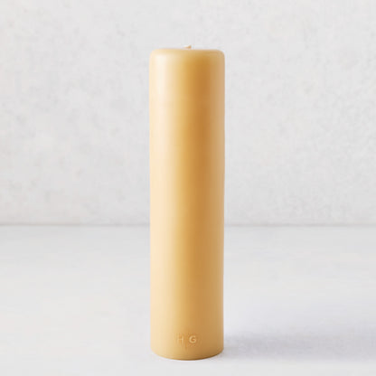 3x12 amber unscented pillar candle with a gold HG logo, hand-dipped from natural paraffin and tree resin.