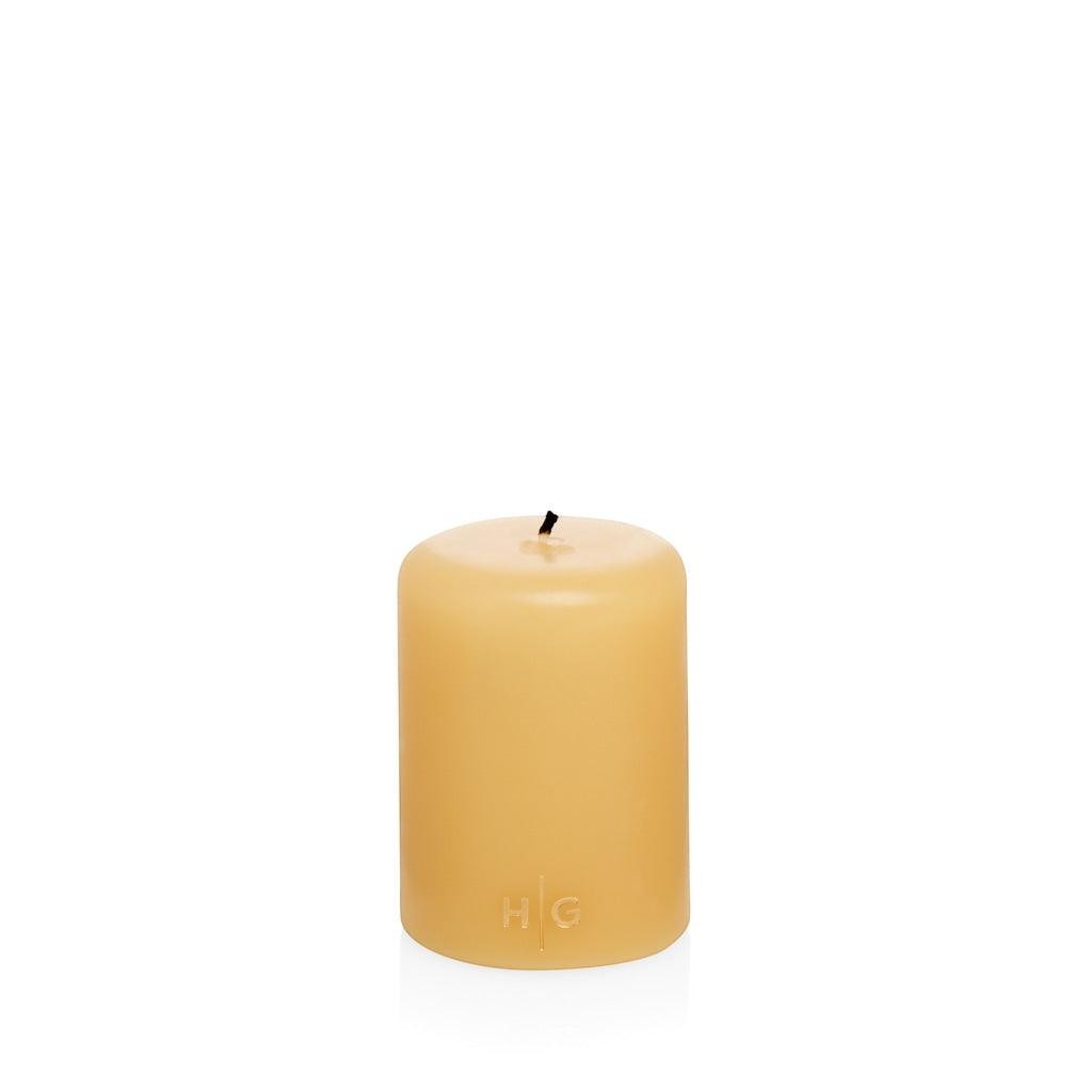 HG Amber Unscented Pillar Candle, 3"x4", with gold HG logo embossed on front.