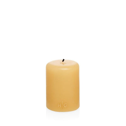 HG Amber Unscented Pillar Candle, 3"x4", with gold HG logo embossed on front.