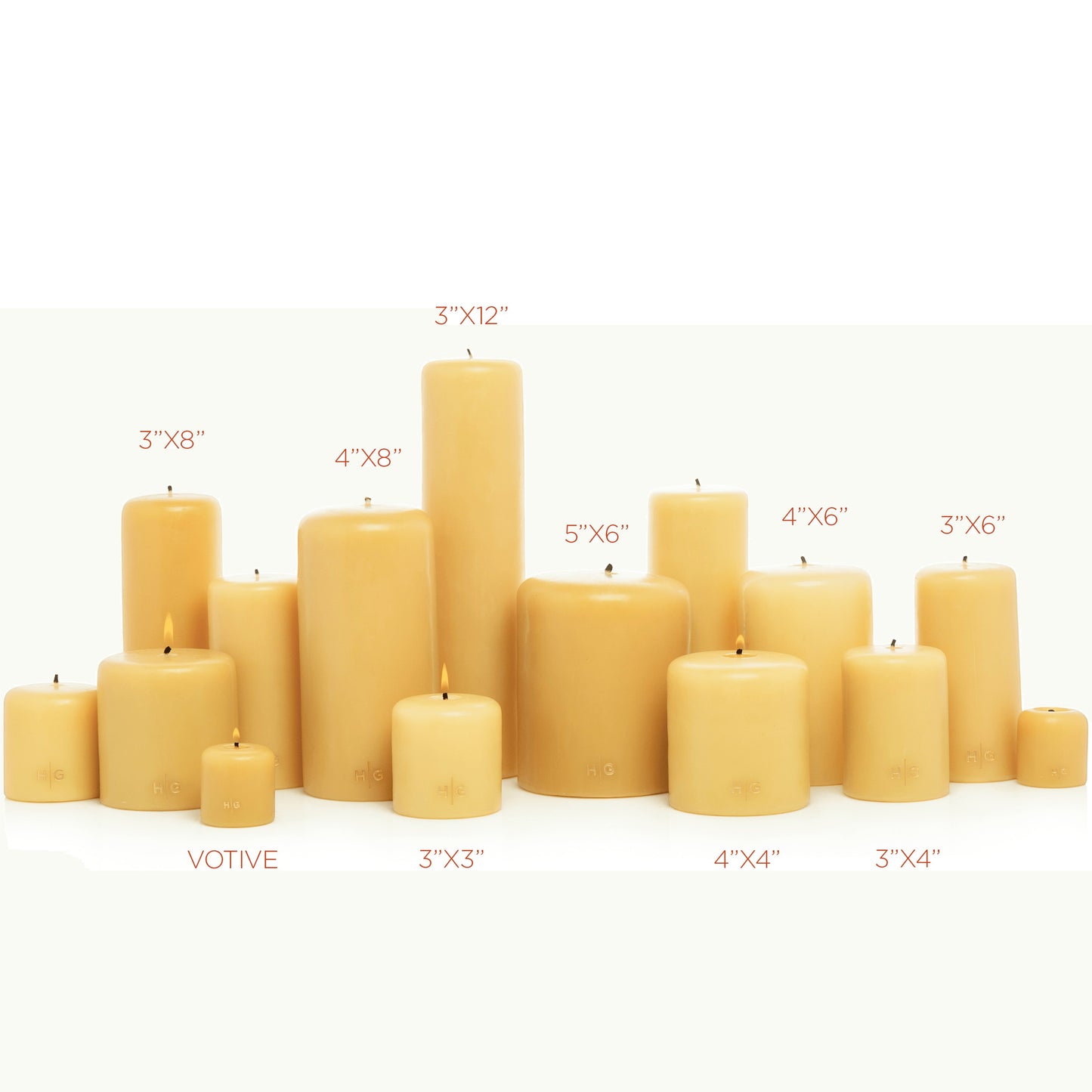 Collection of unscented HG Amber paraffin pillar candles in various sizes with gold HG logo.