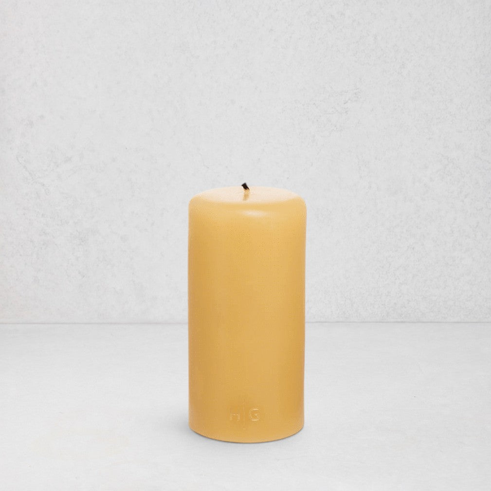 HG Amber Unscented 3"x6" paraffin pillar candle with gold embossed HG logo and cotton wick.
