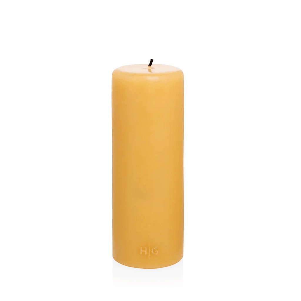 HG Amber Unscented Pillar Candle, 3"x8", made from natural paraffin with a gold HG logo.