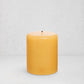 HG Amber Unscented Pillar Candle, 5"x6" paraffin, with gold HG logo and cotton wick.