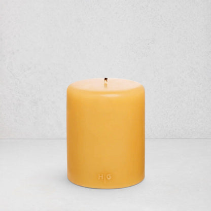 HG Amber Unscented Pillar Candle, 5"x6" paraffin, with gold HG logo and cotton wick.
