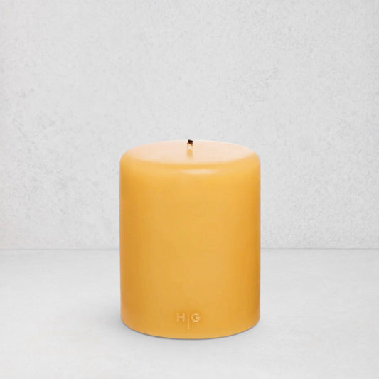 HG Amber Unscented Pillar Candle, 5"x6" paraffin, with gold HG logo and cotton wick.
