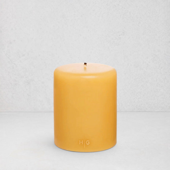 HG Amber Unscented Pillar Candle, 5"x6" paraffin, with gold HG logo and cotton wick.