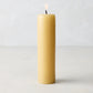 HG Amber Unscented Taper Candle, 7" x 1 3/4" hand-dipped paraffin pillar with gold HG logo, lit wick.