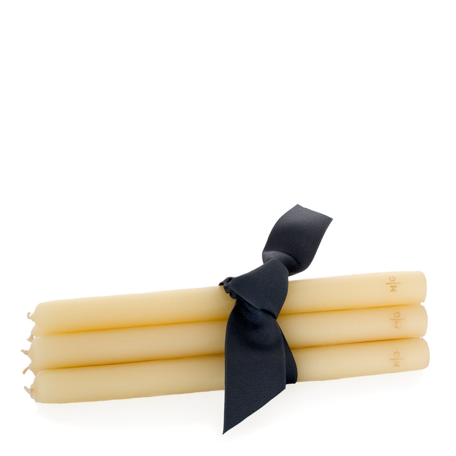 Set of five 10-inch amber unscented taper candles tied with a black ribbon, featuring a gold embossed HG logo.