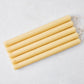 Set of five 12-inch amber unscented taper candles with gold HG logo embossing and cotton wicks.