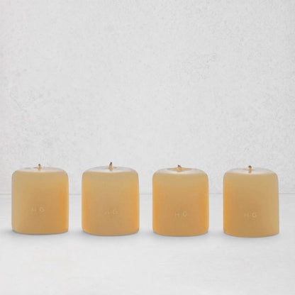 Set of 4 HG Amber Unscented 2" Votive Candles, hand-dipped paraffin with gold HG logo.