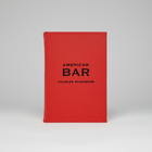 Red leather-bound American Bar book by Charles Schumann with black text.