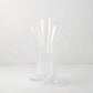 Angelina Small Scissor-Cut Glass Vase: Clear, handmade, thick glass vase with stair-step fluted tubes on a circular base.