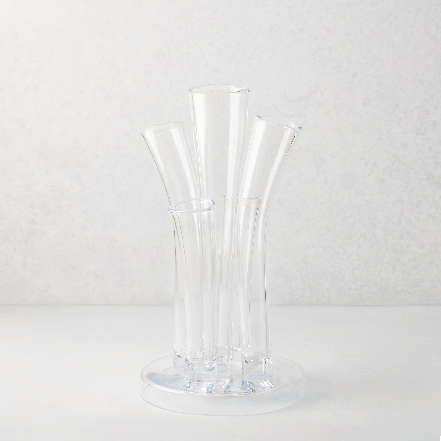 Angelina Small Scissor-Cut Glass Vase: Clear, handmade, thick glass vase with stair-step fluted tubes on a circular base.