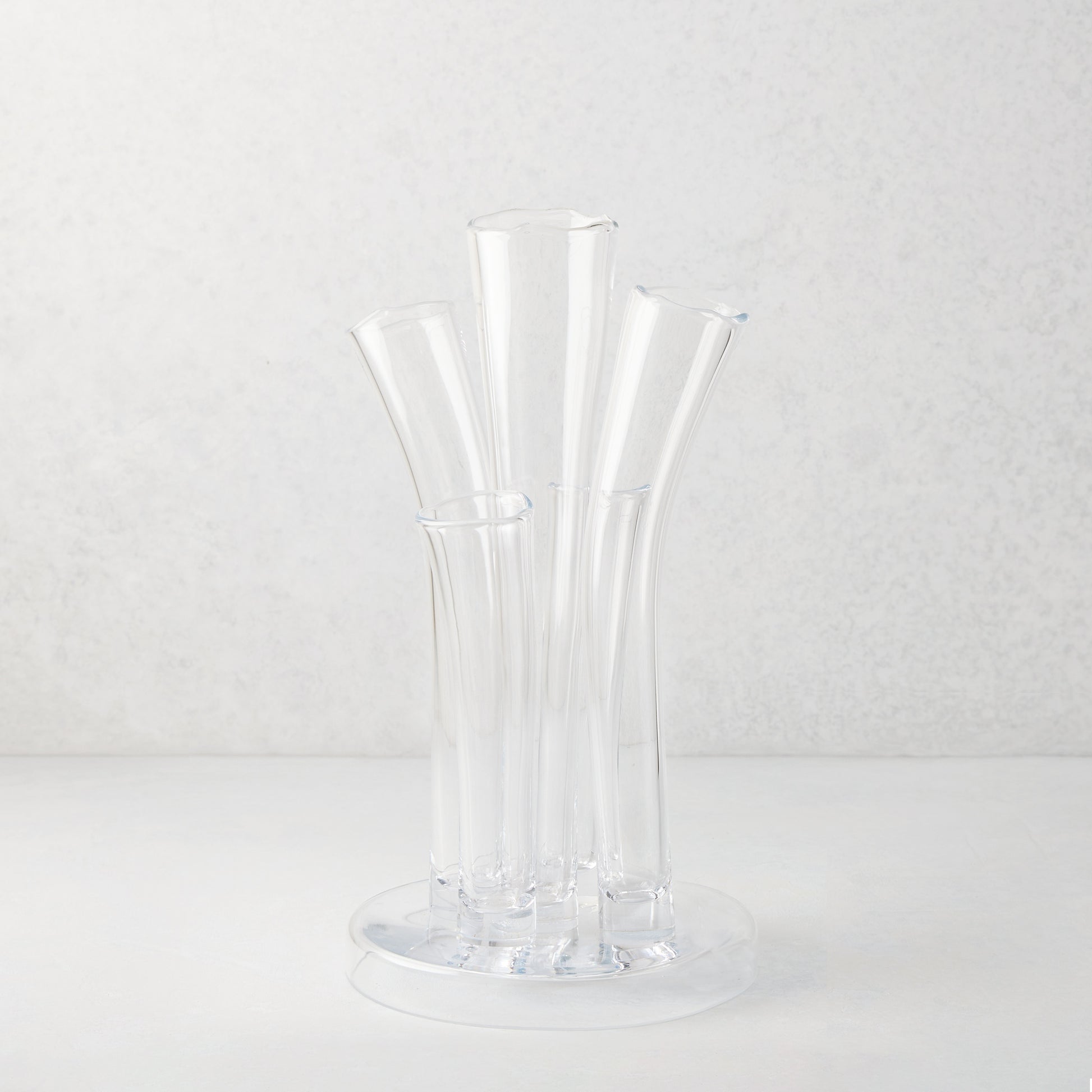 Angelina Small Scissor-Cut Glass Vase: Clear, handmade, thick glass vase with stair-step fluted tubes on a circular base.
