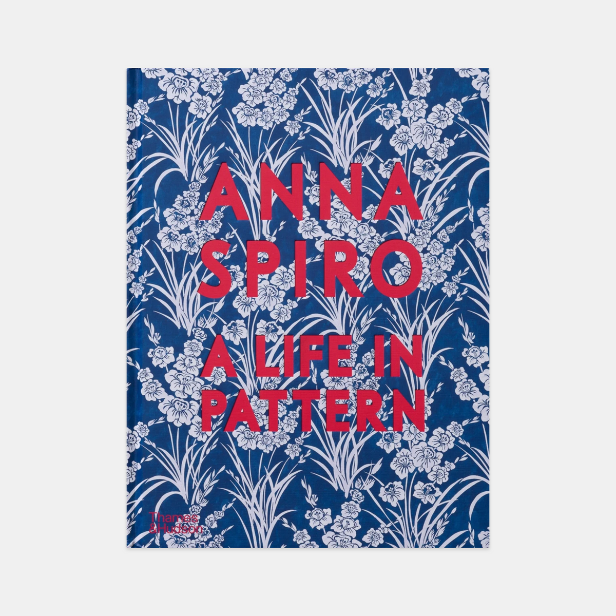 Hardcover book "Anna Spiro: A Life in Pattern" with blue floral design and red title text.