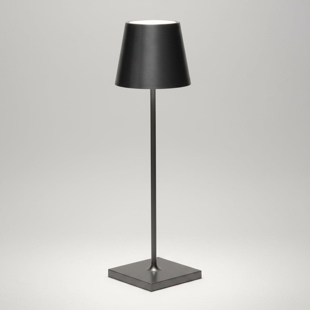 Antique Nickel Poldina Pro rechargeable LED lamp, sleek black metal with a conical shade and square base.