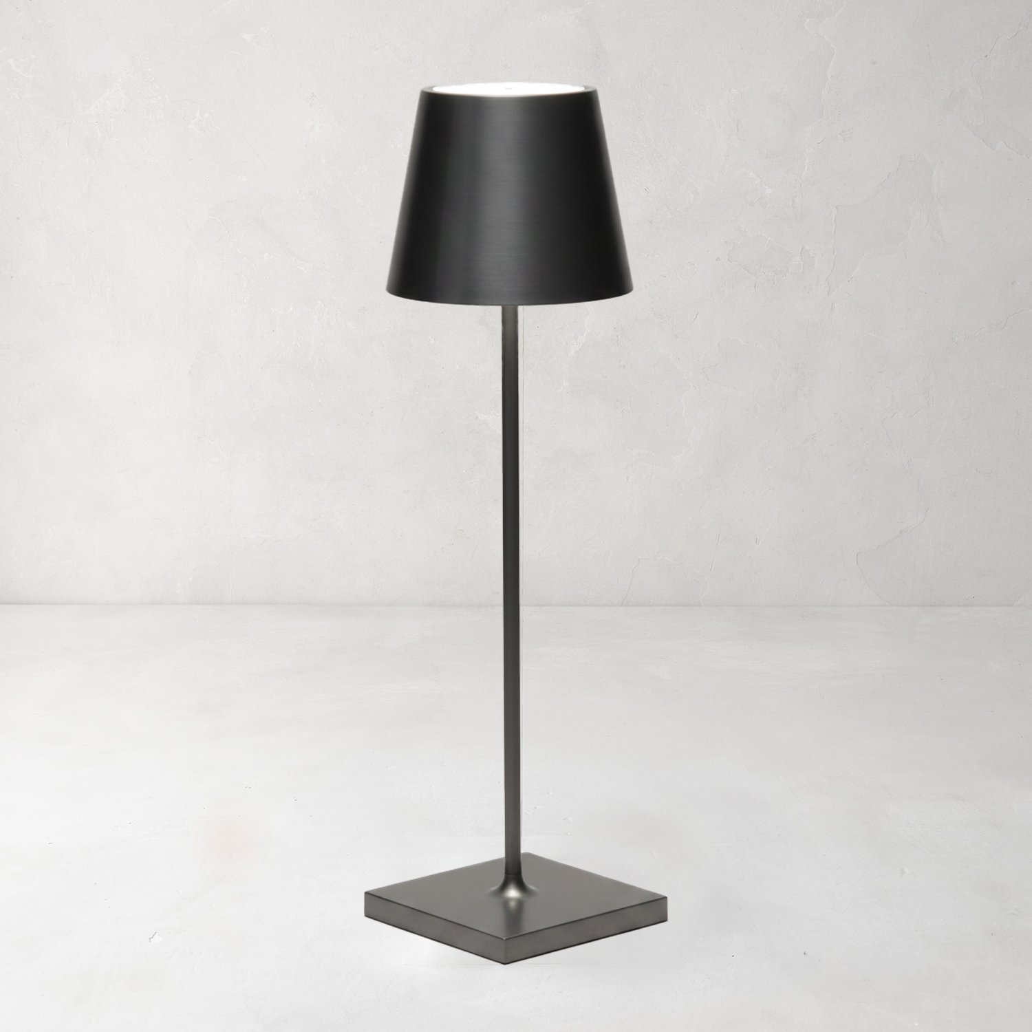 Antique Nickel Poldina Pro rechargeable LED lamp with a dark, sleek, minimalistic design and square base.