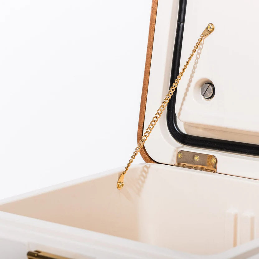 Antique White Hemingway Cooler, 55 Quart, open with acacia wood lid, gold chain, and stainless steel hinge.