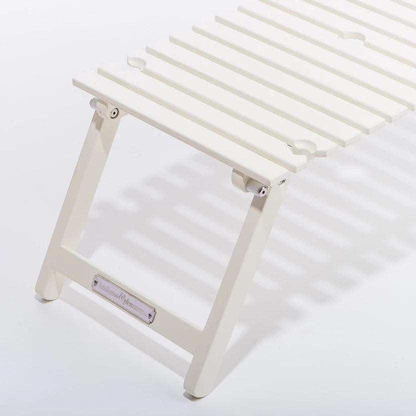 Antique white slatted hardwood outdoor picnic table with folding legs and wine glass holders.