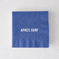 Blue 5.5" square paper cocktail napkin with "APRÉS SURF" in white text.