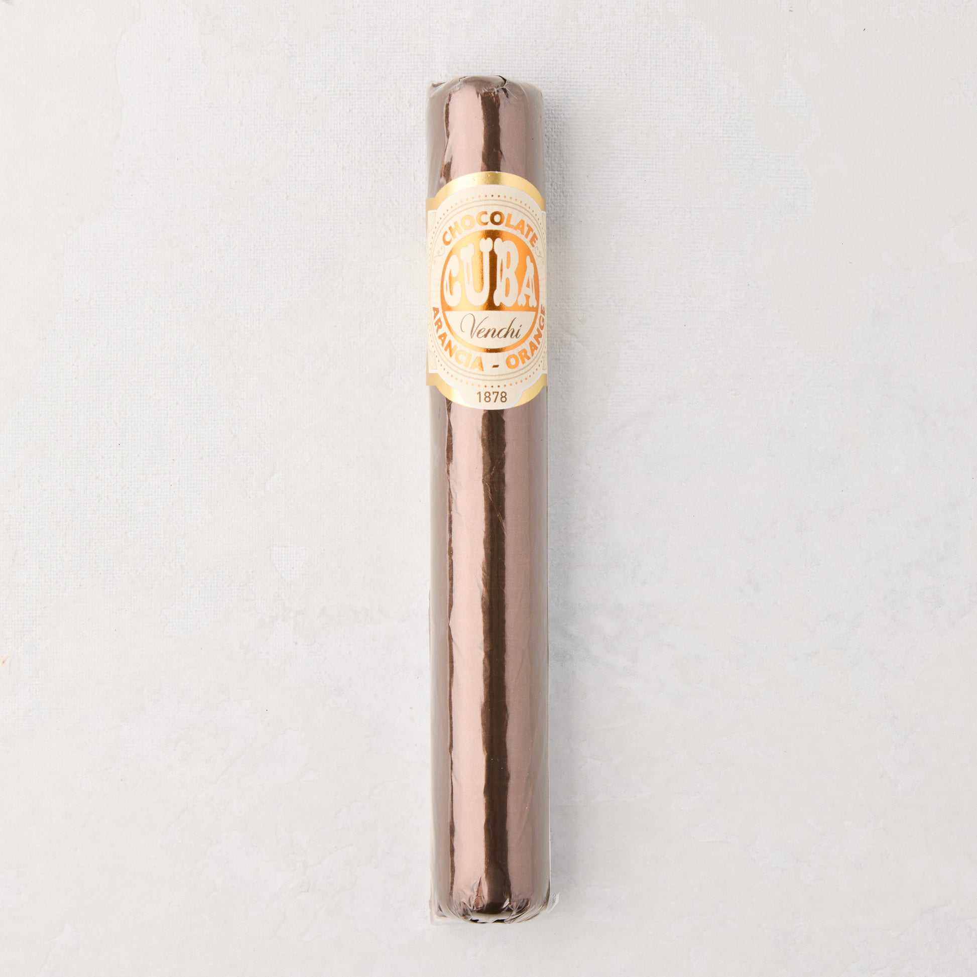 Brown chocolate cigar wrapped in clear plastic with a gold and white "Cuba" label.
