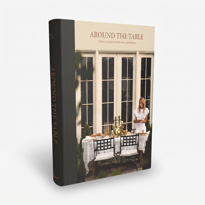 Around the Table hardcover book by Shea McGee with a black spine and a cream cover featuring a dining scene.