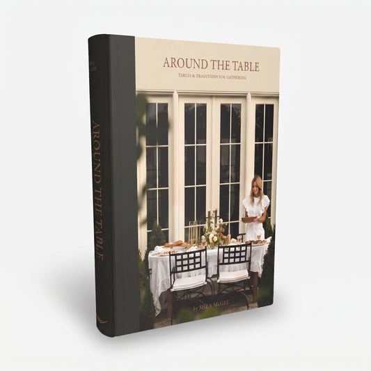 Around the Table hardcover book by Shea McGee with a black spine and a cream cover featuring a dining scene.