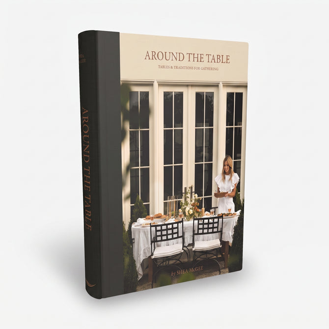 Around the Table hardcover book by Shea McGee with a black spine and a cream cover featuring a dining scene.