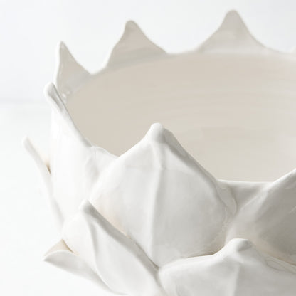 White ceramic footed bowl shaped like an artichoke with layered leaf detailing, 14-inch diameter.