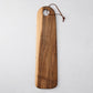 Long oval olive wood serving board with natural grain, hole, and leather cord.