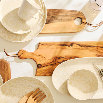 Artisan rectangular olive wood serving board with leather cord, 21.5"L x 7"W, on a white tablecloth.