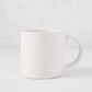 Artisan Stoneware Mug, creamy white glaze, large handle, clean edges.