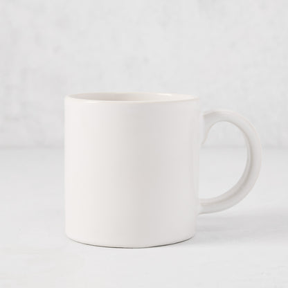 Artisan Stoneware Mug, creamy white glaze, large handle, clean edges.