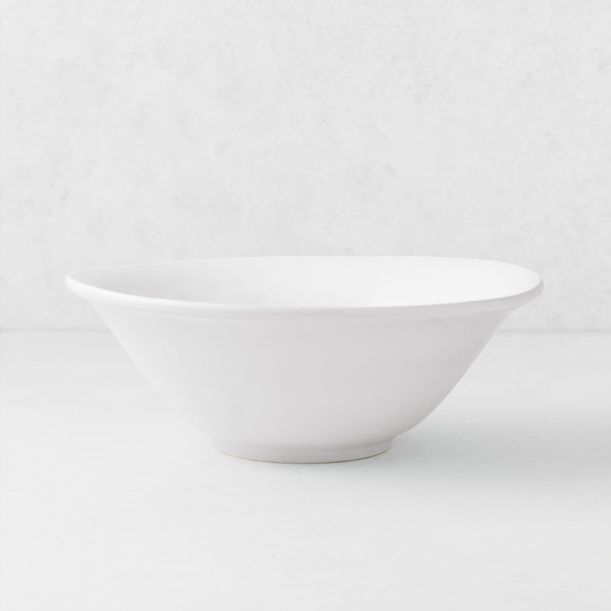 Artisan Stoneware Serve Bowl, creamy white, with a curved lip and clean edges.