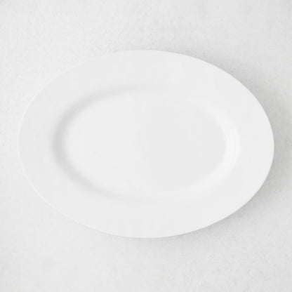 Artisan Stoneware Serve Platter, creamy white oval stoneware platter with a wide lip.