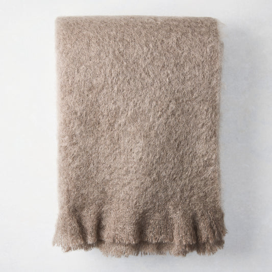Ashwood Brown Mohair Throw Blanket, folded, with a soft, fuzzy texture and fringed edge.