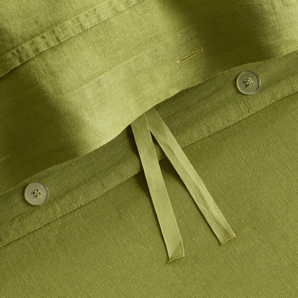 Avocado green washed linen duvet cover with button closures and fabric ties from the Hudson Grace collection.