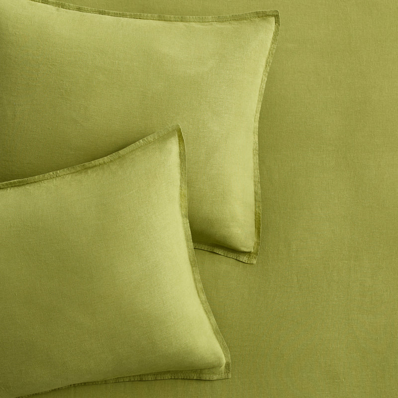 Set of two avocado green European washed linen euro shams with a soft, textured finish.