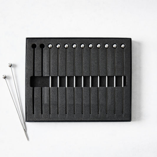 Set of 12 short 4" stainless steel cocktail picks with ball tops, in black foam packaging.
