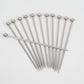 Set of 12 stainless steel cocktail picks with ball tops, fanned out on a white background.