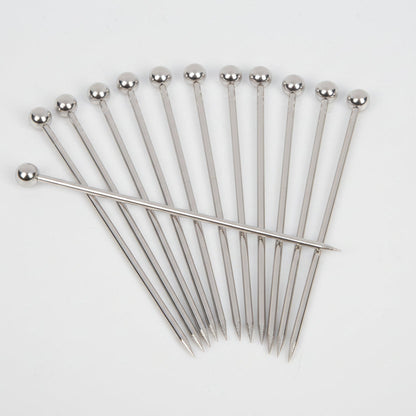Set of 12 stainless steel cocktail picks with ball tops, fanned out on a white background.