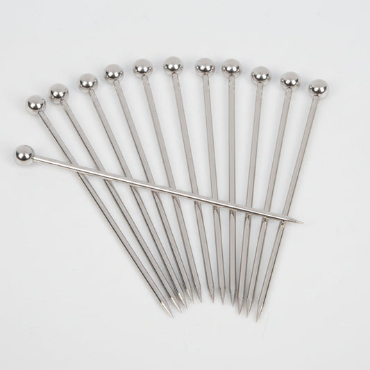 Set of 12 stainless steel cocktail picks with ball tops, fanned out on a white background.