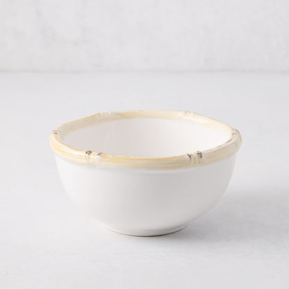 White ceramic nut bowl with a natural-edge, bamboo-inspired rim.