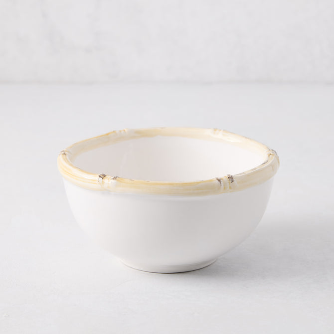 White ceramic nut bowl with a natural-edge, bamboo-inspired rim.